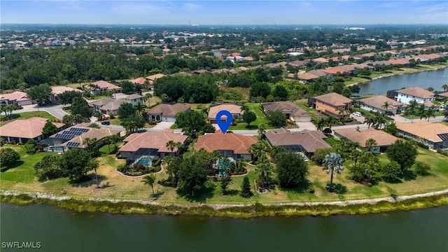 drone / aerial view with a water view and a residential view
