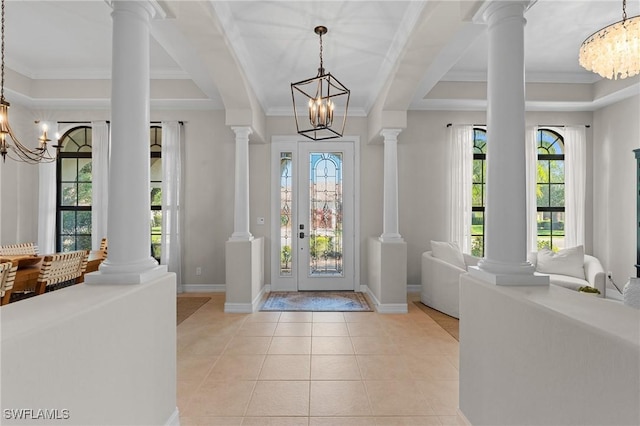 entryway featuring an inviting chandelier, light tile patterned floors, crown molding, and baseboards
