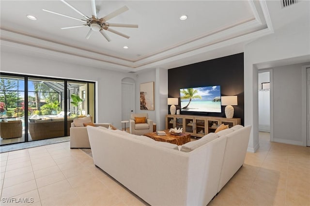 living room with light tile patterned floors, a tray ceiling, recessed lighting, and visible vents