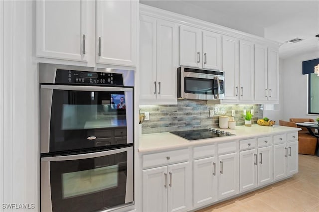 kitchen with light countertops, white cabinetry, tasteful backsplash, and stainless steel appliances