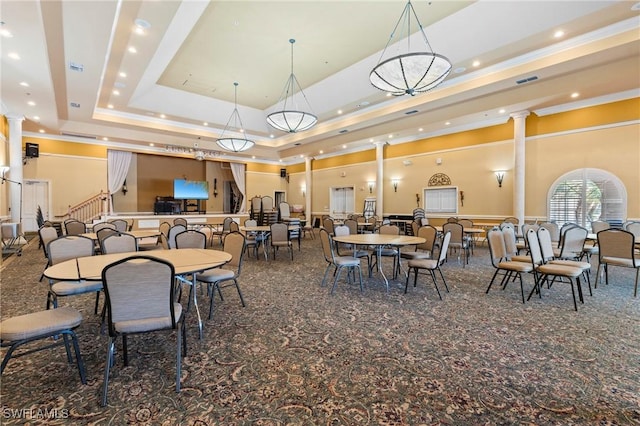 carpeted dining room featuring visible vents, ornamental molding, decorative columns, recessed lighting, and a tray ceiling