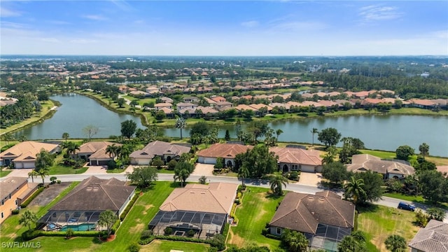 drone / aerial view featuring a residential view and a water view