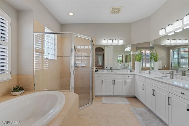 full bathroom featuring visible vents, vanity, tile patterned floors, a bath, and a shower stall