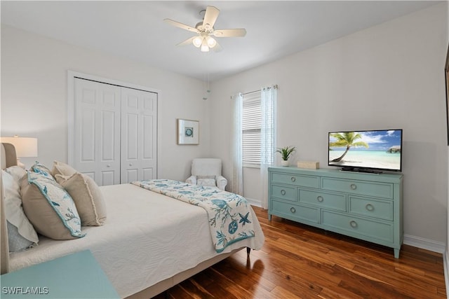 bedroom featuring baseboards, ceiling fan, a closet, and dark wood-style floors