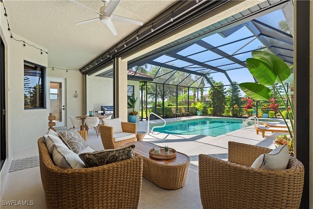 outdoor pool featuring glass enclosure, a patio, and a ceiling fan