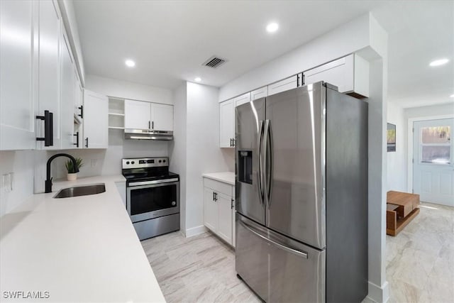 1115 Central Dr, Naples, FL 34104 - kitchen with a sink, light countertops, under cabinet range hood, stainless steel appliances, and white cabinetry
