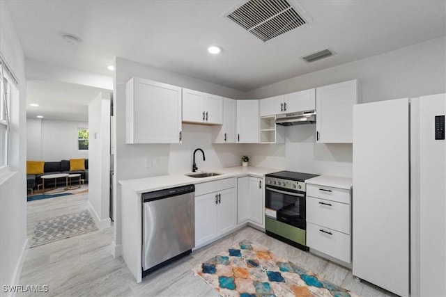 1115 Central Dr, Naples, FL 34104 - kitchen with visible vents, appliances with stainless steel finishes, a sink, light countertops, and white cabinetry