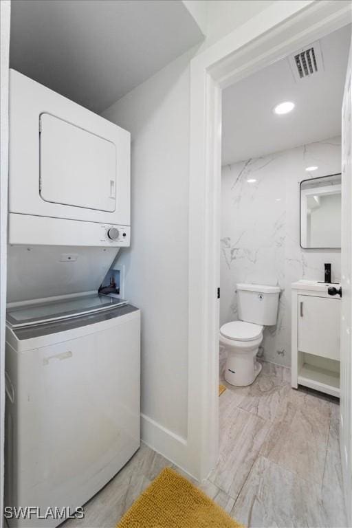 1115 Central Dr, Naples, FL 34104 - bathroom with stacked washer and dryer, visible vents, vanity, toilet, and recessed lighting