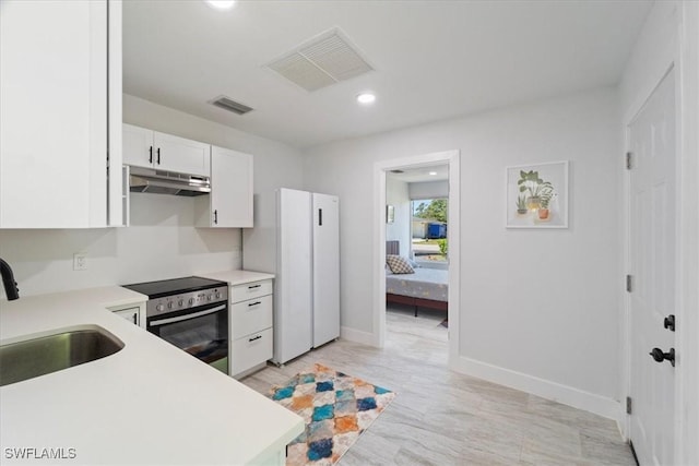 1115 Central Dr, Naples, FL 34104 - kitchen featuring under cabinet range hood, visible vents, a sink, and stainless steel range with electric stovetop