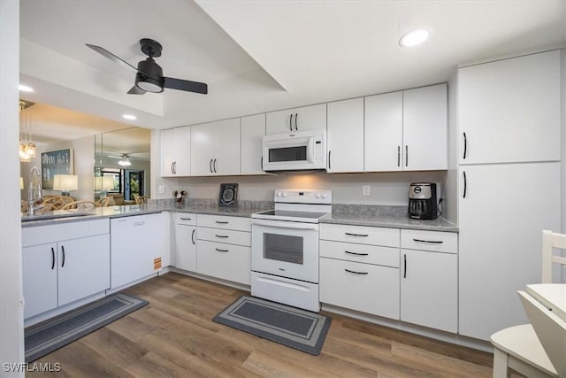 527 Lake Louise Cir Unit 101, Naples, FL 34110 - kitchen with a sink, white appliances, white cabinets, a ceiling fan, and dark wood finished floors