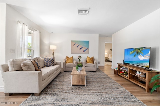 3565 Balboa Cir W, Naples, FL 34105 - living area featuring wood finished floors, visible vents, and baseboards