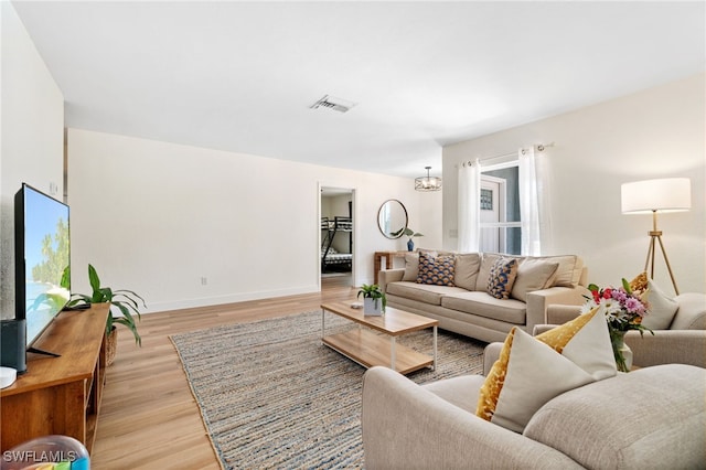 3565 Balboa Cir W, Naples, FL 34105 - living area with light wood finished floors, visible vents, a chandelier, and baseboards