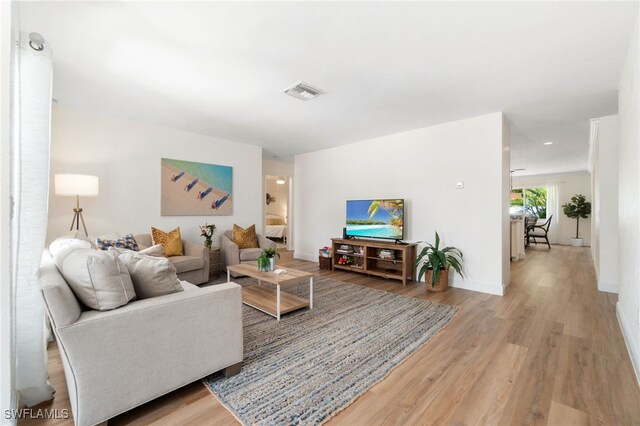 3565 Balboa Cir W, Naples, FL 34105 - living room with visible vents, wood finished floors, and baseboards