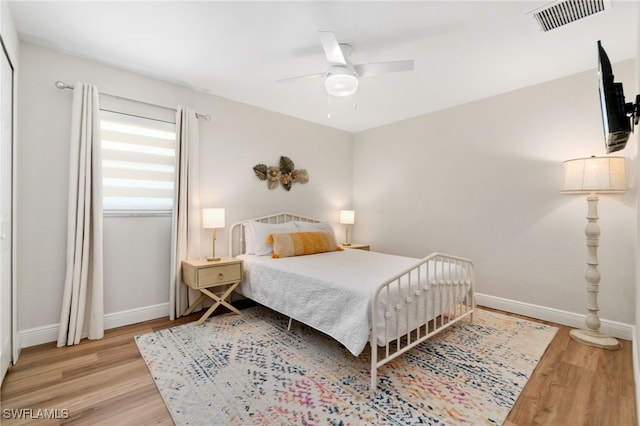 3565 Balboa Cir W, Naples, FL 34105 - bedroom with baseboards, visible vents, wood finished floors, and a ceiling fan