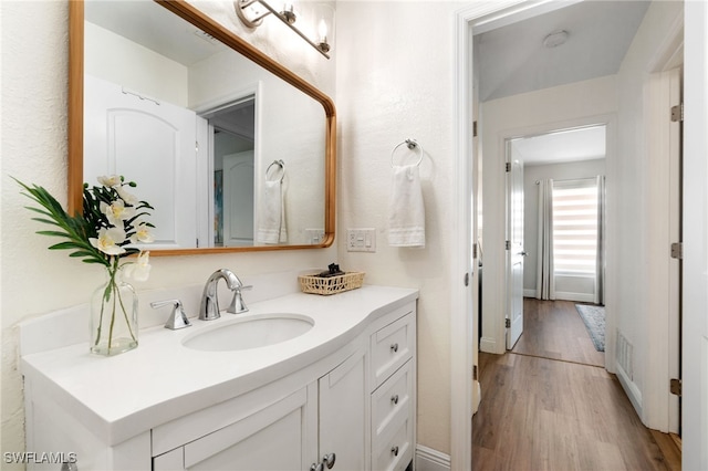 3565 Balboa Cir W, Naples, FL 34105 - bathroom with vanity and wood finished floors
