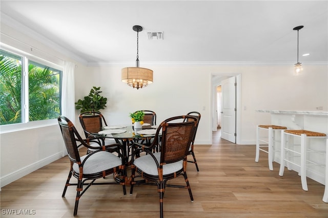 3565 Balboa Cir W, Naples, FL 34105 - dining space featuring visible vents, crown molding, light wood finished floors, and baseboards