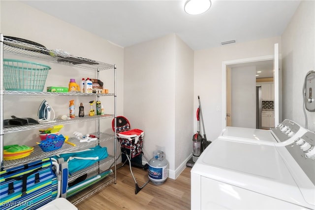 3565 Balboa Cir W, Naples, FL 34105 - washroom with separate washer and dryer, laundry area, light wood-type flooring, visible vents, and baseboards