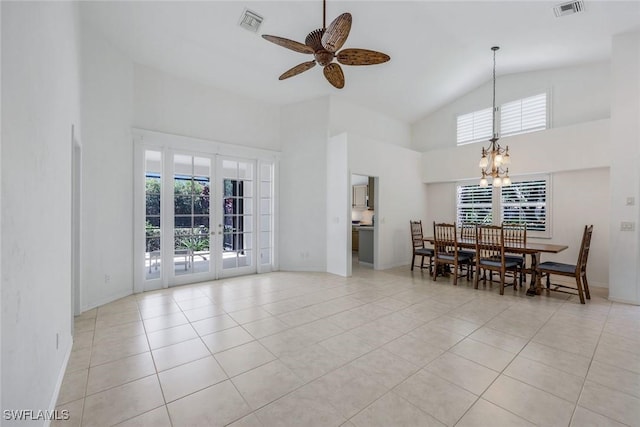dining room with a healthy amount of sunlight, high vaulted ceiling, light tile patterned floors, and visible vents