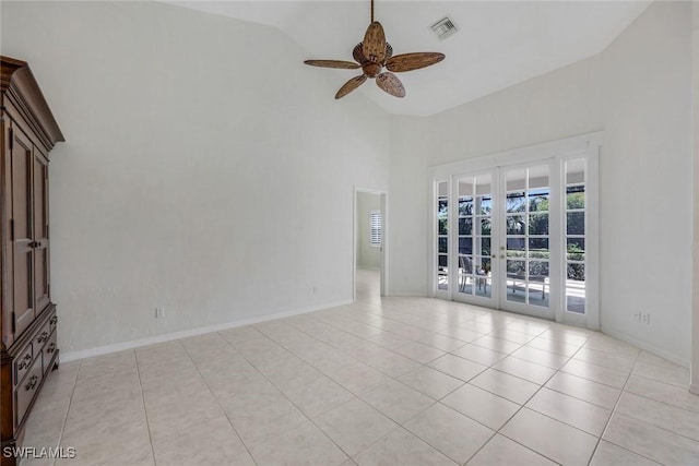 empty room with light tile patterned flooring, high vaulted ceiling, french doors, a ceiling fan, and visible vents