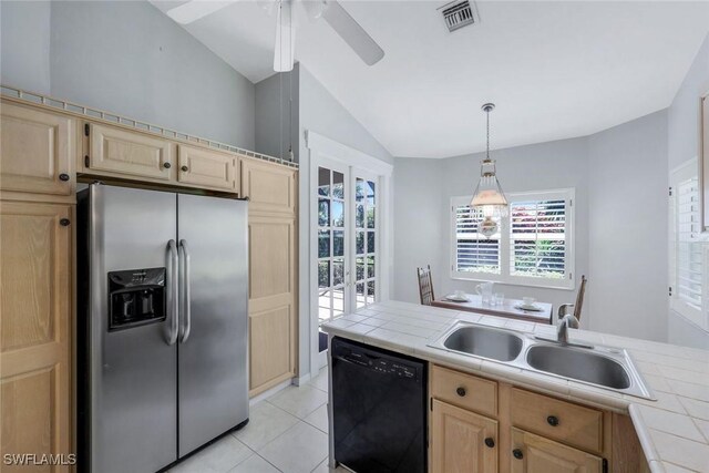 kitchen featuring light brown cabinetry, black dishwasher, stainless steel refrigerator with ice dispenser, and tile countertops