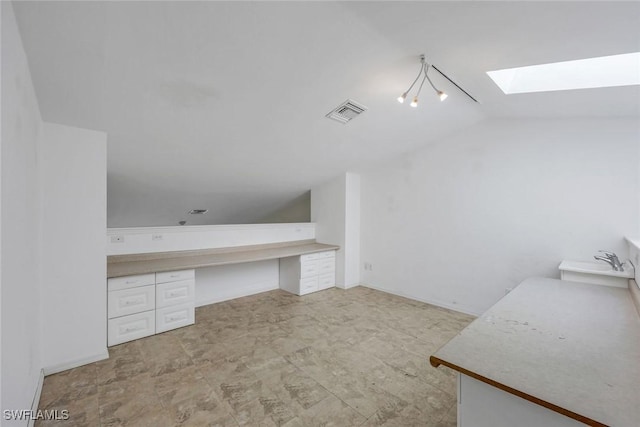 interior space with visible vents, a sink, and lofted ceiling with skylight