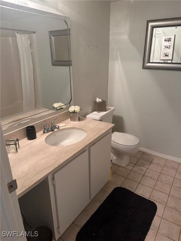 2385 Naples Trace Cir Unit 1, Naples, FL 34109 - full bathroom featuring a shower with curtain, tile patterned floors, baseboards, vanity, and toilet