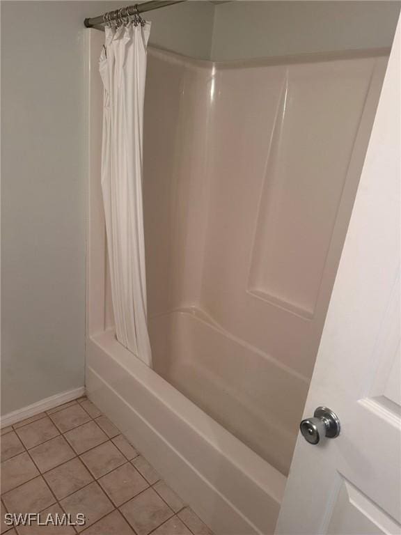2385 Naples Trace Cir Unit 1, Naples, FL 34109 - bathroom with tile patterned floors, baseboards, and shower / tub combo