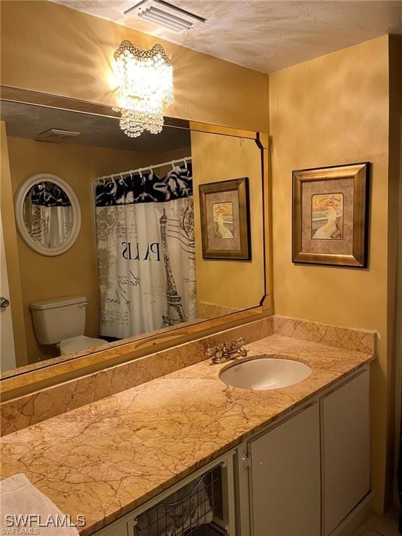 2385 Naples Trace Cir Unit 1, Naples, FL 34109 - bathroom featuring visible vents, a notable chandelier, toilet, and vanity