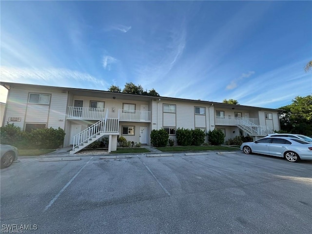 2385 Naples Trace Cir Unit 1, Naples, FL 34109 - view of front facade with stairway and uncovered parking