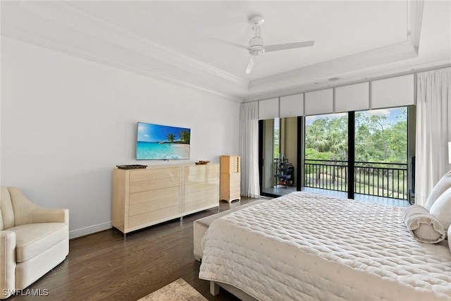 bedroom with crown molding, wood finished floors, access to exterior, baseboards, and a raised ceiling