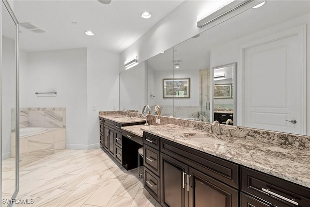 bathroom featuring a garden tub, vanity, marble finish floor, baseboards, and a shower stall