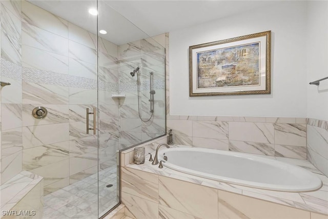 full bath with a shower stall, recessed lighting, and a bath