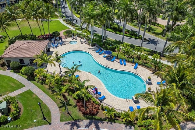view of pool featuring a lawn