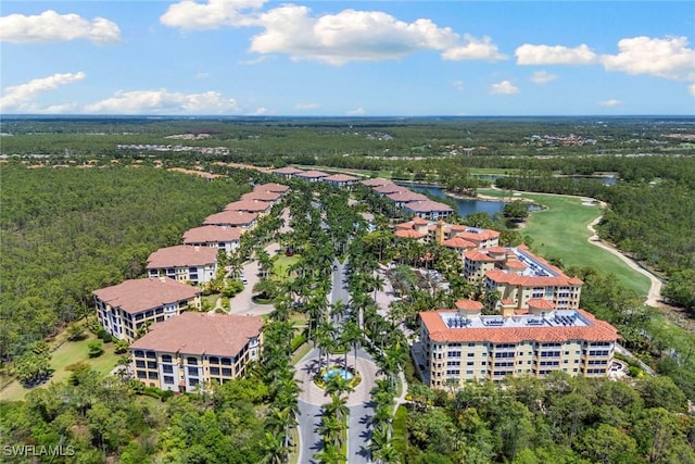 bird's eye view with a water view and a view of trees