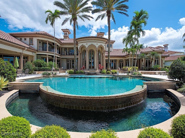 9663 Mashie Ct, Naples, FL 34108 - view of swimming pool featuring a pool with connected hot tub and a patio