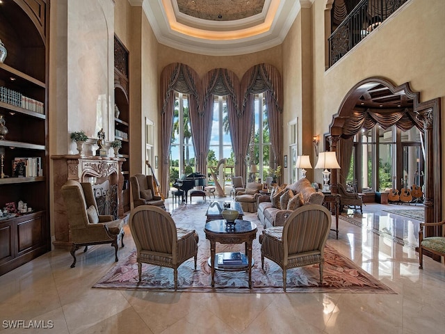 9663 Mashie Ct, Naples, FL 34108 - sitting room with a towering ceiling, ornamental molding, built in features, and healthy amount of natural light