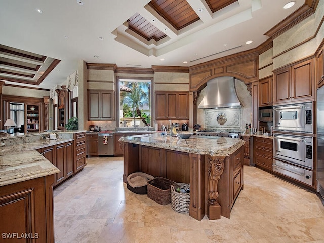 9663 Mashie Ct, Naples, FL 34108 - kitchen featuring a warming drawer, wall chimney range hood, a large island, backsplash, and coffered ceiling
