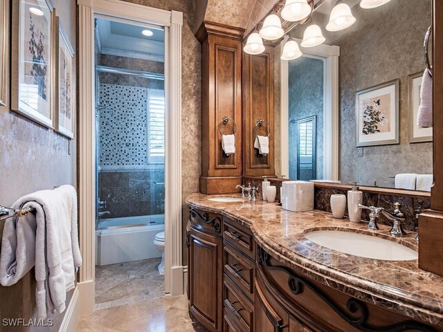 9663 Mashie Ct, Naples, FL 34108 - full bathroom featuring toilet, double vanity, combined bath / shower with glass door, and a chandelier