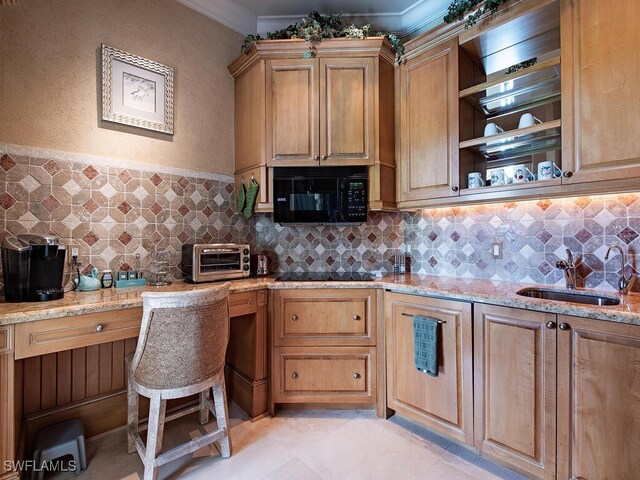 9663 Mashie Ct, Naples, FL 34108 - kitchen with black appliances, a sink, light stone counters, backsplash, and crown molding