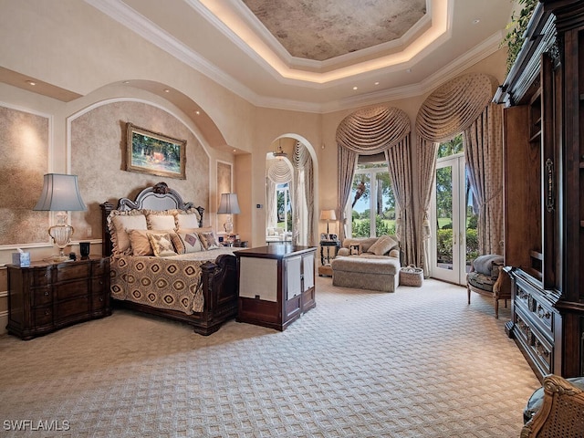 9663 Mashie Ct, Naples, FL 34108 - carpeted bedroom featuring crown molding, a tray ceiling, access to exterior, and a towering ceiling