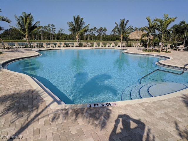 pool with fence and a patio