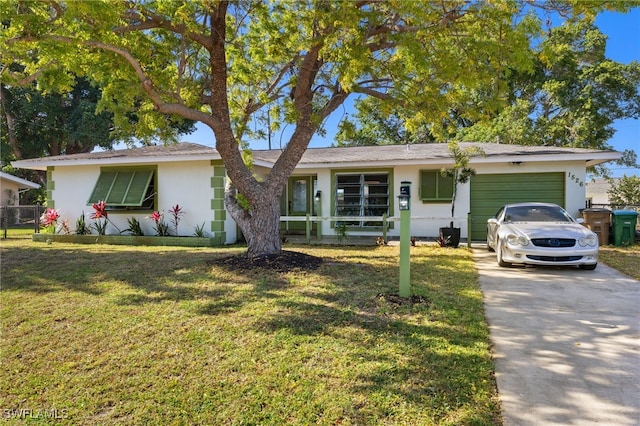 single story home featuring stucco siding, an attached garage, driveway, and a front lawn
