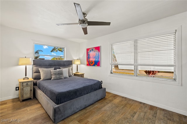 bedroom with baseboards, a ceiling fan, and wood finished floors