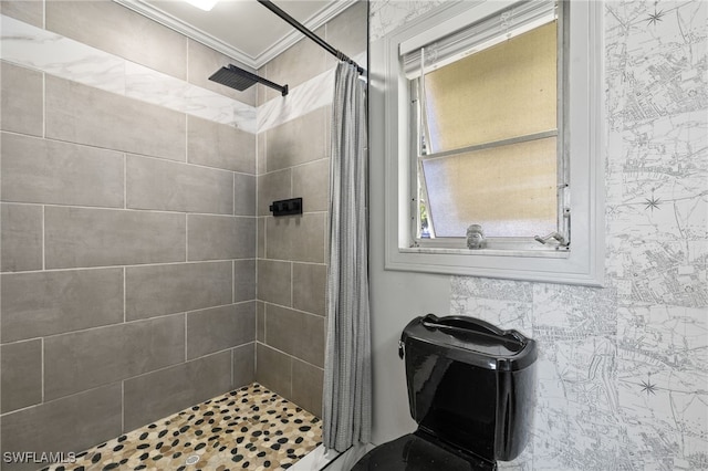 bathroom featuring ornamental molding and tiled shower