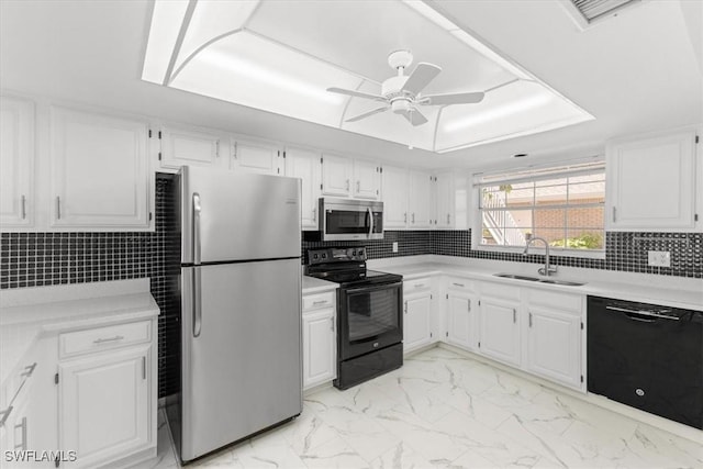 kitchen featuring a sink, ceiling fan, black appliances, light countertops, and white cabinets