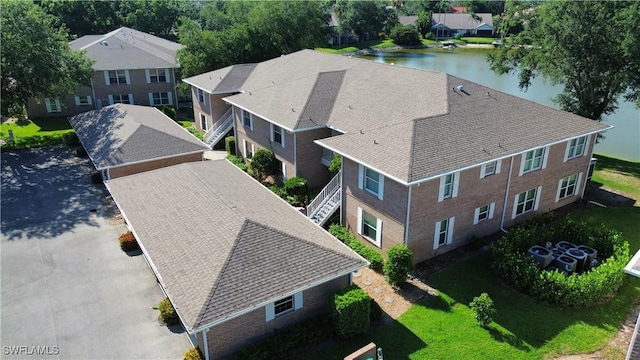 birds eye view of property with a residential view and a water view