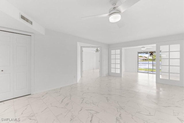 interior space with baseboards, visible vents, ceiling fan, and marble finish floor
