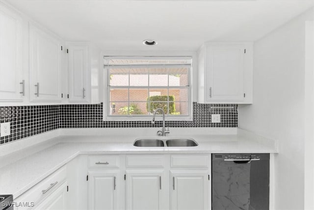 kitchen featuring dishwasher, white cabinets, and a sink