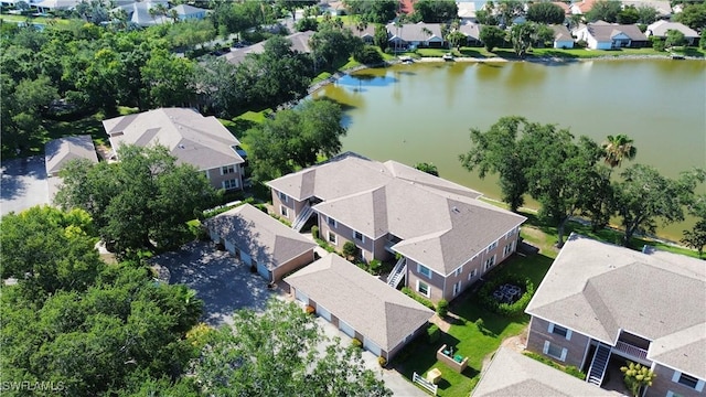 drone / aerial view with a residential view and a water view