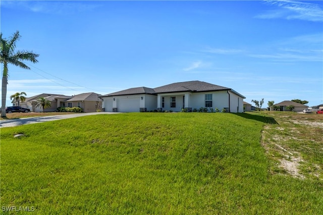 prairie-style home with concrete driveway, a garage, a front lawn, and stucco siding